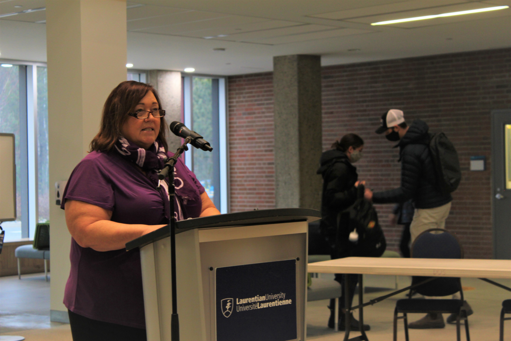 Marlene Gorman at the podium in Laurentian University's Atrium.