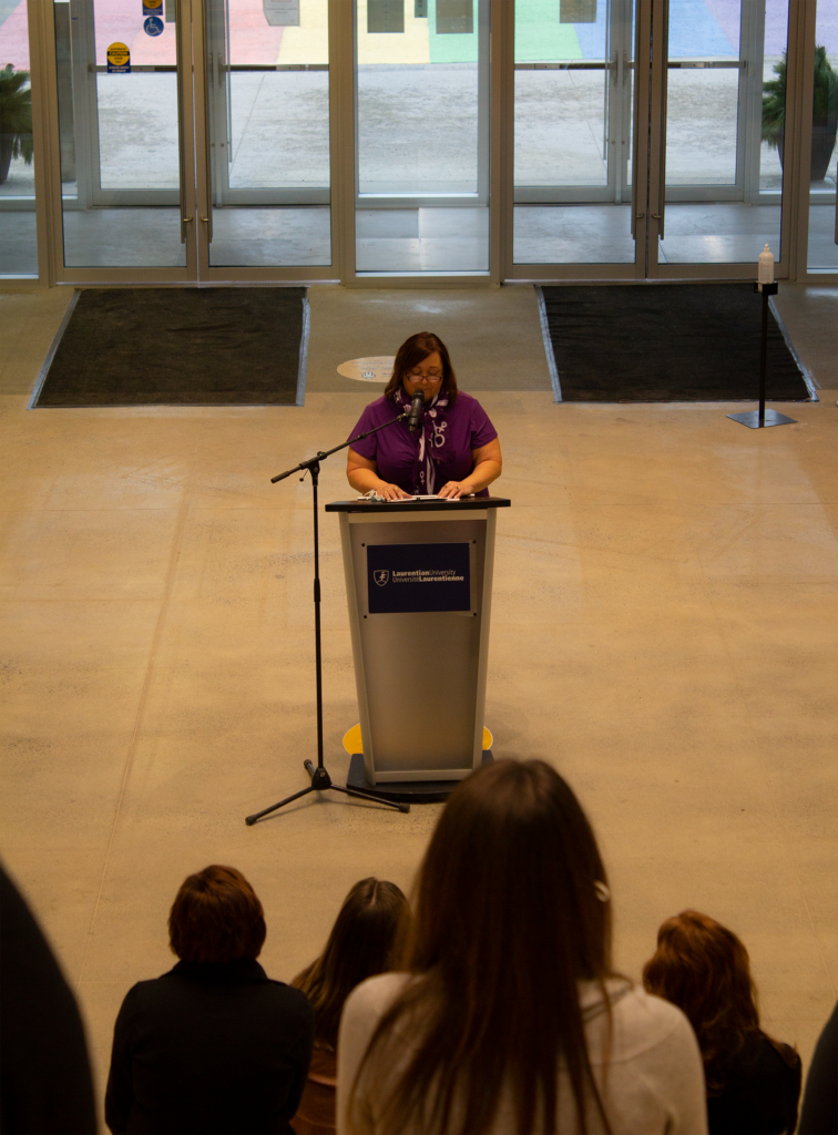 YWCA Sudbury's Executive Director, Marlene Gorman, addresses the crowd in Laurentian University's Atrium.